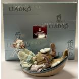 A Lladro Privilege model of a youthful clown in a tug boat, number 11IX8, 24cm long, printed mark in