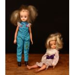 A 1980's Sindy doll, blonde hair, side glancing blue eyes, wearing a floral patterned dress in tones