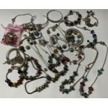 A large collection of Pandora type bracelets, necklaces, etc