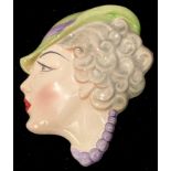 An Art Deco wall mask, as a lady wearing hat, Copes & Co., No.1, 19cm high