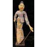 An Indonesian Wayang Golek puppet, on stand, 55cm high overall