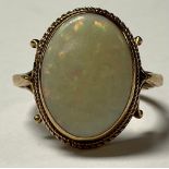 A gold coloured metal and opal ring, unmarked, 4.2g