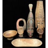 Tribal Art - an elongated African mask, 85cm high; another; turned bowls; etc (5)