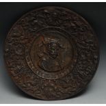 A 19th century Continental circular cast metal plate, the central field cast with a gentleman with