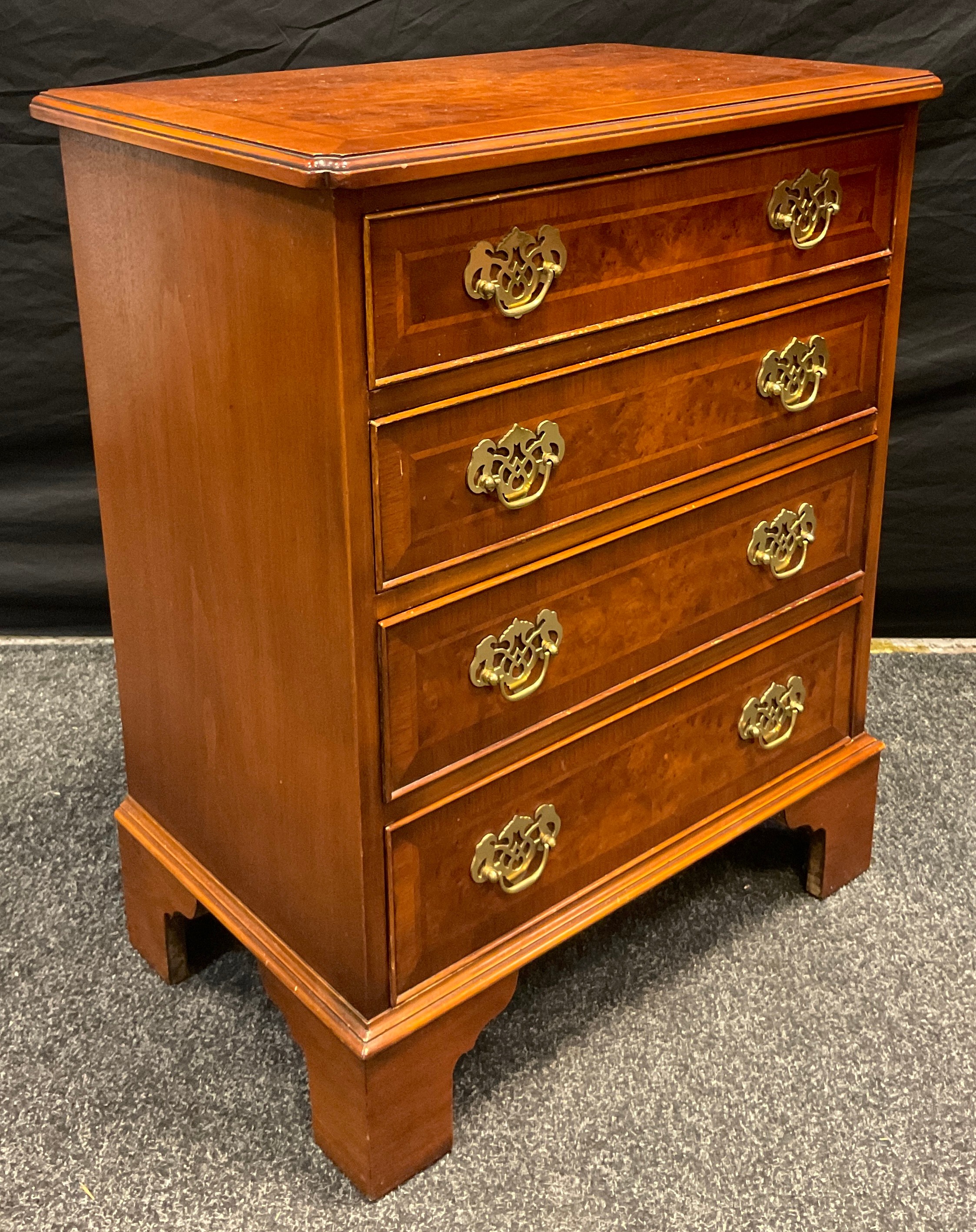 A small George III style burr walnut and walnut reproduction chest of drawers, with four graduated