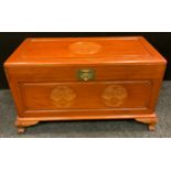 A Chinese camphor wood chest/blanket box, rounded carved detailing to top and frieze, dragon mask