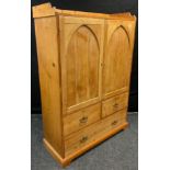 An early 20th century pine hall robe, three quarter galleried top, pair of arch-panel cupboard