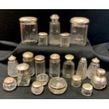 Nine facetted clear glass and silver dressing table jars, various sizes; a silver topped smelling
