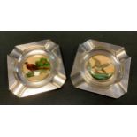 A pair of E.P.N.S. canted square ashtrays, the centres with 'Essex Crystal' type intaglios, of a