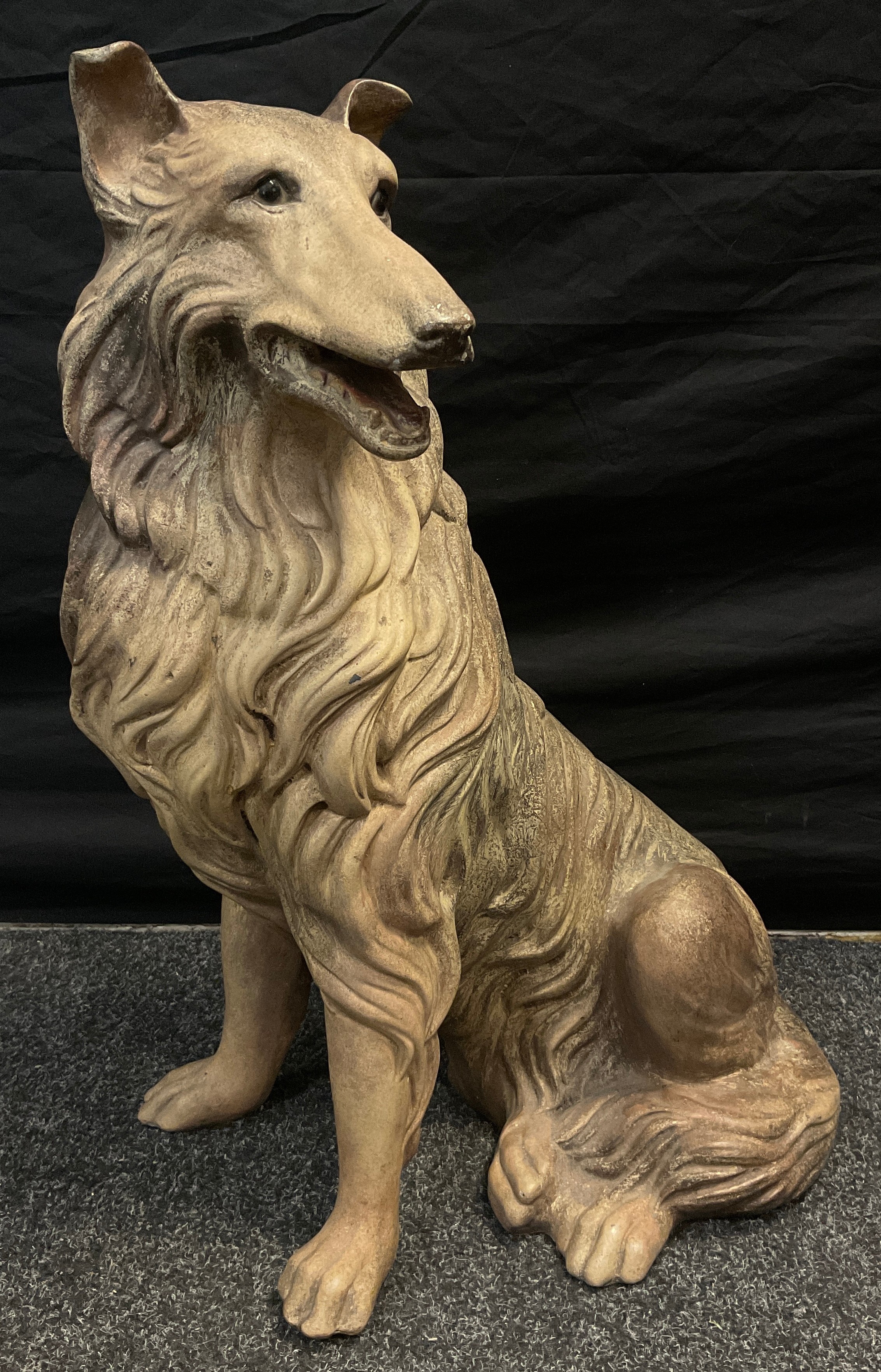 A large ceramic resin hollow cast model of a Rough Collie dog seated, 68cm high