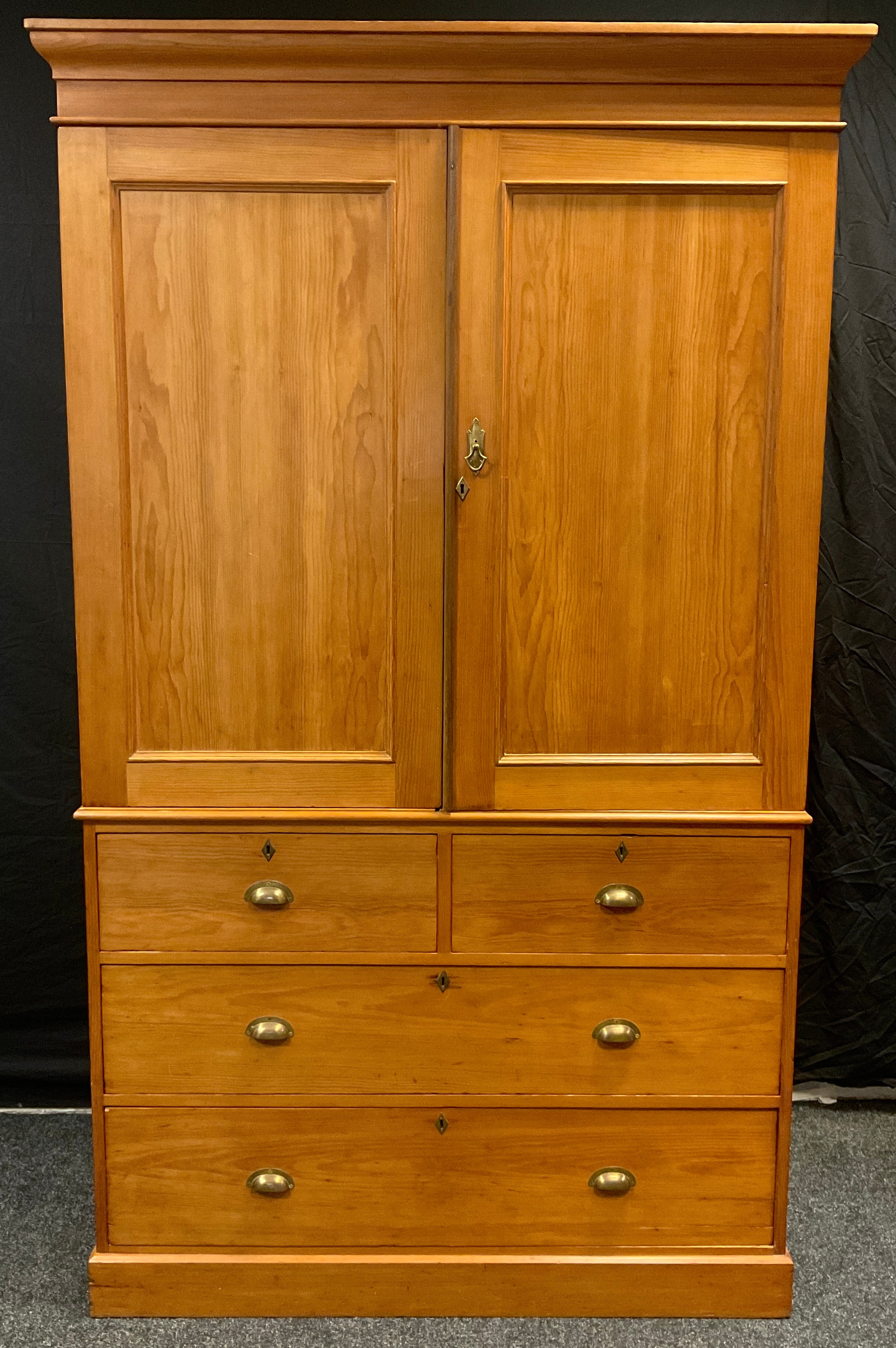 A Victorian pine Linen Press, having moulded cornice with pair of panelled cupboard doors to top