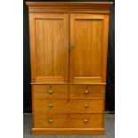 A Victorian pine Linen Press, having moulded cornice with pair of panelled cupboard doors to top