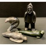 A Canadian Inuit Eskimo carved stone figure, seal, signed, nu 71038, with original lable, others