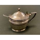 A George III silver oval tankard mustard, chased with foliage, ball finial, angular handle, blue