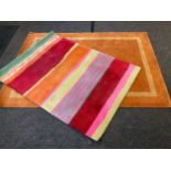 A modern design woollen rug / carpet, with alternating bands in red, orange green and cream, 180cm x