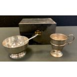 A silver sugar bowl, egg-and-dart border, spoon en suite, Birmingham 1957, boxed; a silver