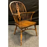 A 20th century oak and beechwood Windsor chair, pierced splat, spindle back, crinoline stretcher,