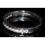 A platinum channel set fourteen stone diamond chip ring, size J/K, marked 950, 3.8g