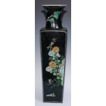 A large Chinese famille noir tapered slab-sided vase, painted in polychrome enamels with panels of
