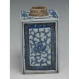 An 18th century Chinese square tea caddy, painted in tones of underglaze blue with scrolling foliage