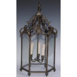 An early 20th century bronze hexagonal hall ceiling lantern, shaped arched crestings, each glazed