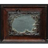 An Art Nouveau rectangular oak and bronzed mirror, signed with initials C.H., embossed and pierced