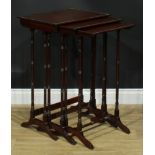 A nest of three George III Revival mahogany occasional tables, each with a rectangular top, turned