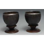 A pair of 18th centurty silver mounted coconut cups, each carved with fluted roundels and Rococo