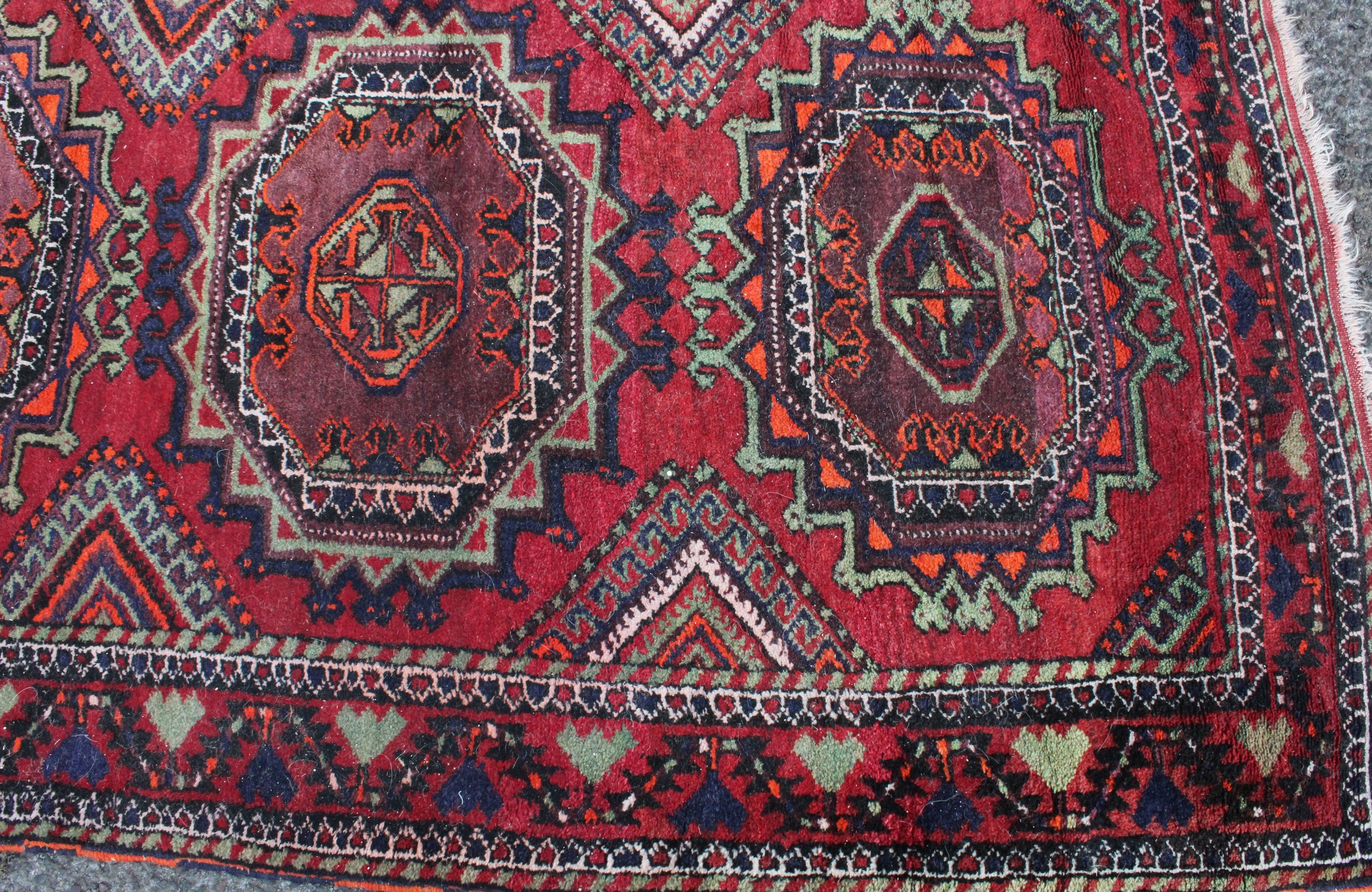 A Middle Eastern rectangular wool rug or carpet, the field worked with hooked medallions and - Image 2 of 5