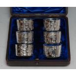 A set of six Edwardian silver plated napkin rings, bright-cut engraved and numbered, 4.5cm diam, c.