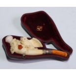 A late 19th century meerschaum pipe, carved as an owl perched on branch, an amber owlet peering