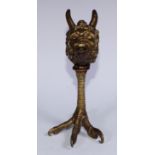 A Renaissance Revival gilt bronze lamp, cast as the head of Pan, raised on a talon support, 20cm