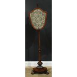 A William IV rosewood pole screen, pointed knop finial, shield shaped banner embroidered with