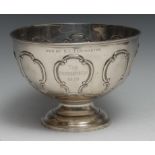 An Edwardian silver pedestal rose bowl, embossed with a band of C-scroll cartouches, domed foot,