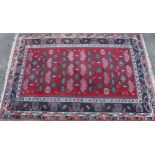 A Middle Eastern rectangular wool rug or carpet, the field worked with hooked medallions and