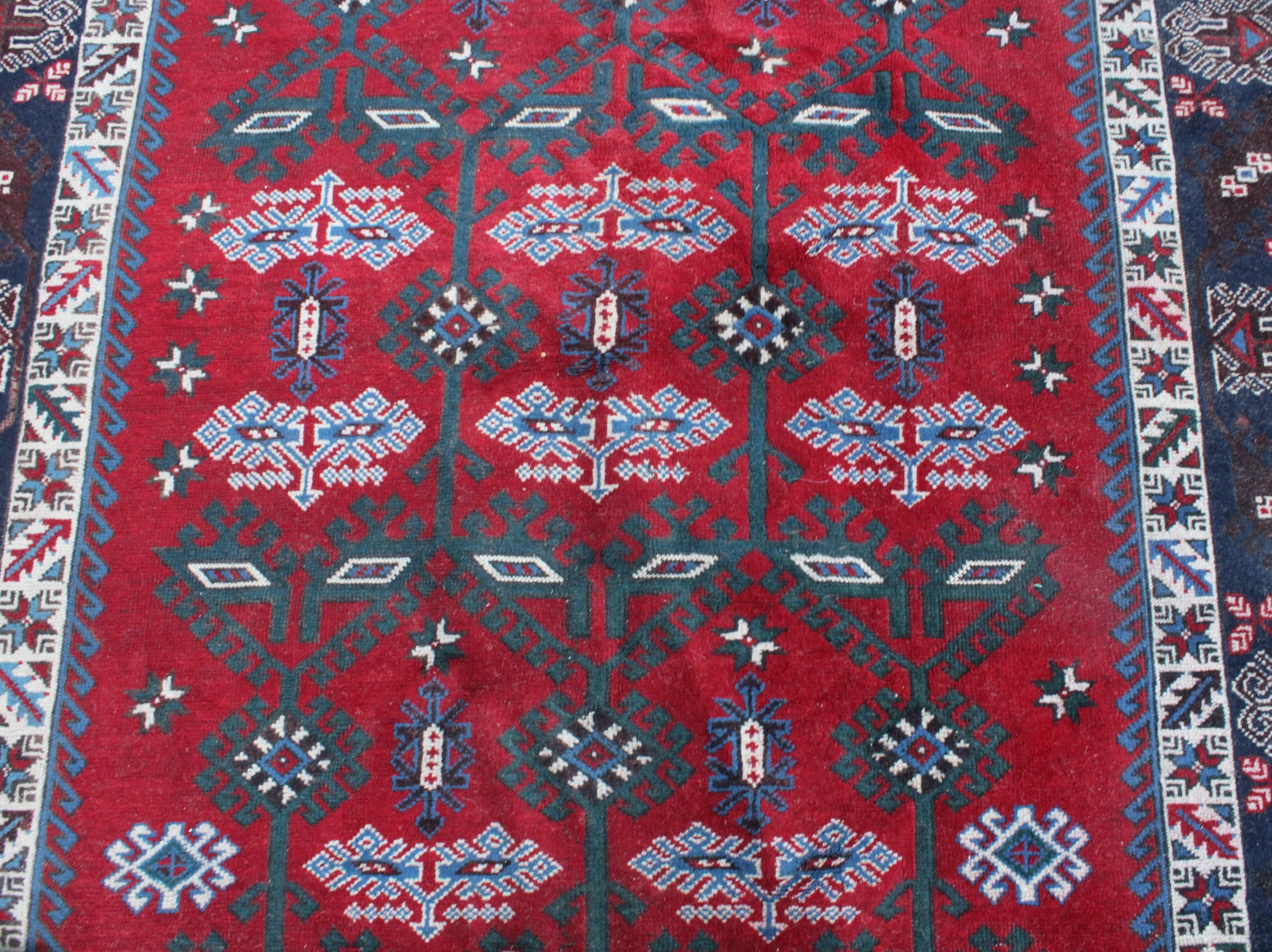 A Middle Eastern rectangular wool rug or carpet, the field worked with hooked medallions and - Image 4 of 5