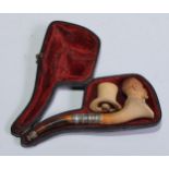 A late 19th century meerschaum pipe, carved as a gentleman, bust length, his top hat en suite,