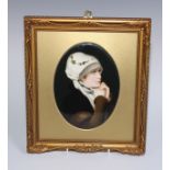 A German porcelain oval plaque, painted with a portrait of a lady, 18.5cm x 14cm, gilt frame, 29cm x