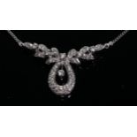 An diamond and 18ct white gold ribbon tied pendant necklace, the central poop with diamond