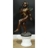 Continental School, a brown patinated and cold painted bronze, of an amorini, 85cm high, marble