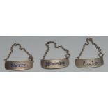 A set of three Elizabeth II silver and enamel curved rounded rectangular wine labels, Port, Sherry