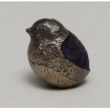 A George V silver miniature pincushion as a chick in a partial egg shell, blue velvet cushion, 2.