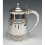 A George III silver tankard, hinged domed cover with ball finial and pierced thumb-piece, above