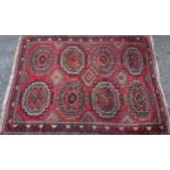 A Middle Eastern rectangular wool rug or carpet, the field worked with hooked medallions and