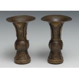 A pair of Chinese bronze gu vases, cast in the archaic taste, 15cm high, 19th century