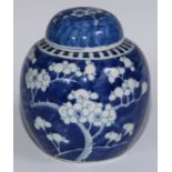 A Chinese ovoid ginger jar and cover, painted in tones of underglaze blue with blossoming prunus