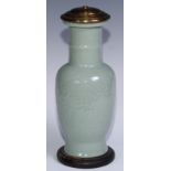 A Chinese celadon ovoid vase, moulded in shallow relief with scrolls, 31.5cm high, later mounted