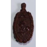 A 19th century coquilla nut scent bottle, carved with a bust length portrait of a lady, 7cm long