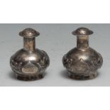 A pair of Chinese silver peppers, chased with dragons, 5cm high, Kwan Wo, Canton c.1900
