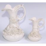 A Belleek ewer, in the white and typically encrusted with flowers, 23.5cm high, second mark, c.